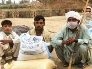 3 Generations of kiln workers from Pakistan getting food from VKP