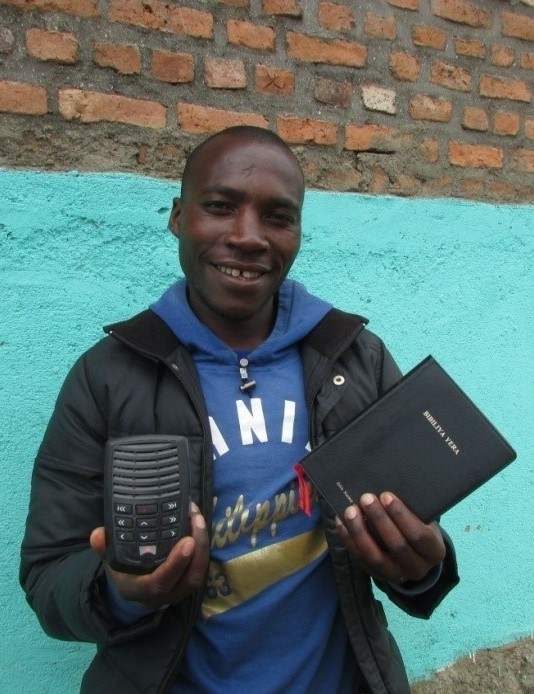 African pastor holding bible and audio player